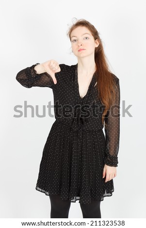 Beautiful businesswoman doing different expressions in different sets of clothes: thumbs down