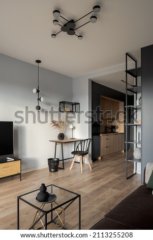 Small and stylish studio apartment with cozy home office space and modern decorations Royalty-Free Stock Photo #2113255208