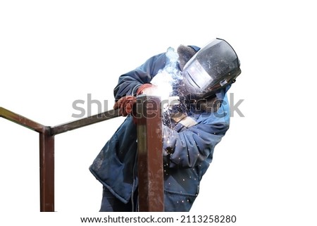 A worker in blue overalls and a protective mask connects metal elements by electric welding. Sparks fly. Isolated on white background.                           Royalty-Free Stock Photo #2113258280