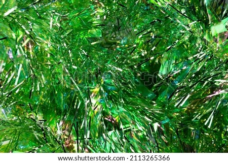 Green tinsel. serpentine, background, blur. holiday new year  Royalty-Free Stock Photo #2113265366