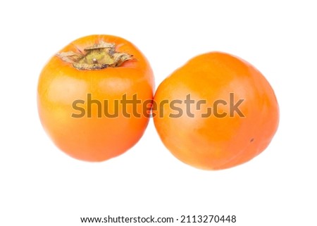 Ripe orange persimmon fruits on a white background. Close up fresh kaki on dark blue.