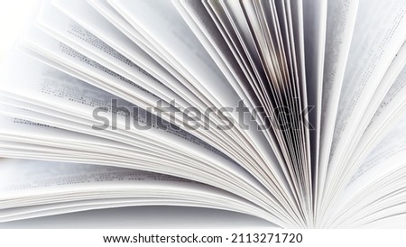 Pages of an open book close-up photography. White pages book side view. The concept of continuing education, visiting libraries, book exhibitions. Royalty-Free Stock Photo #2113271720