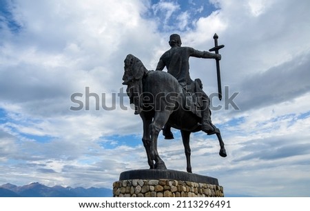 Back view of monument of Erekle II (Heraclius) Georgian king of Kakheti with Caucasian Mountains and clouds sky on background in Telavi, Georgia