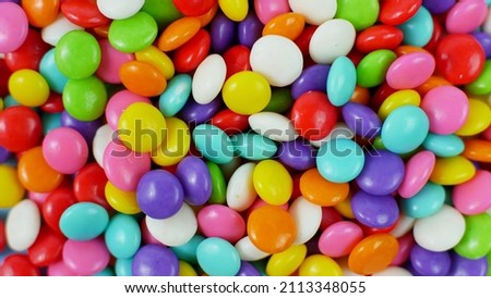 colorful sweet candy balls on blue pastel background. trendy color for wallpaper or background. Royalty-Free Stock Photo #2113348055