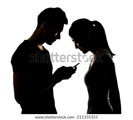 Couple using cellphone, silhouette portrait. Royalty-Free Stock Photo #211335355