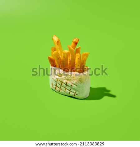 Shawarma ingredients in roll. Supplement for greek gyros - French fries. Fried potatoes in donner kebab. Fast food menu concept. Contemporary ingredients for shawarma. Supplement ingredients Royalty-Free Stock Photo #2113363829