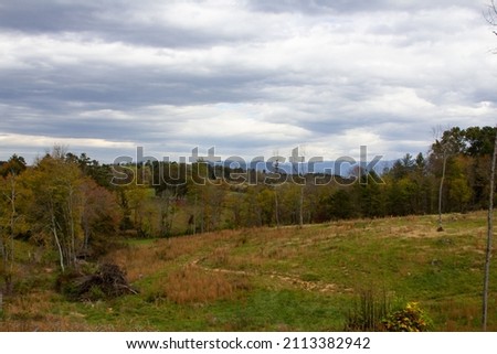 Beautiful photo of a green landscape with blue skies and clouds of Ashville North Carolina's Blue Ridge Mountains during a road from the road
