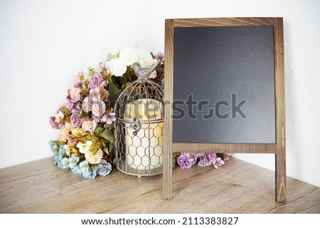 Blank Blackboard wooden easel with flower and LED candle light decoration