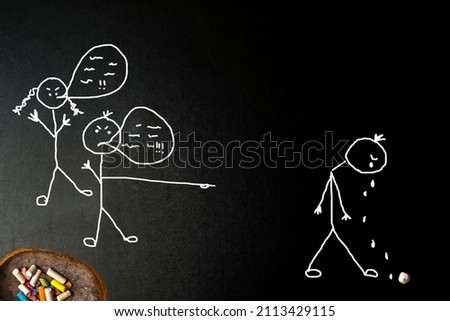  School bullying, verbal harassment, sad child victim of insults and teasing. Freehand drawing on blackboard and chalk
