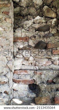 Background of gray concrete stone structure exterior wall of building, which is made from a mixture of portland cement powder, water, sand and gravel