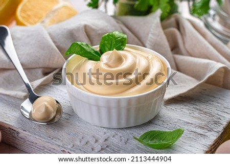 Fresh, natural mayonnaise with basil close-up. Side view, horizontal. Egg sauce Royalty-Free Stock Photo #2113444904