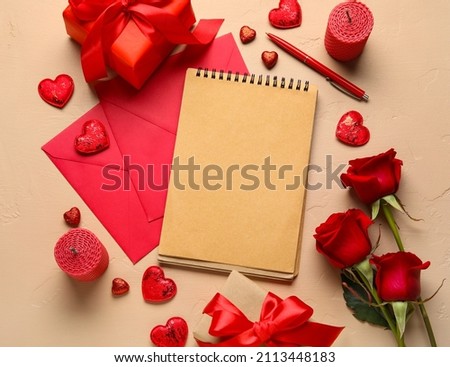 Romantic composition with empty notebook, gifts and envelopes on color background