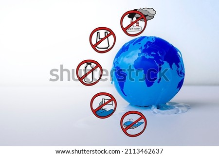 Blue globe wet with water and environmental protection symbol. Ocean day concept