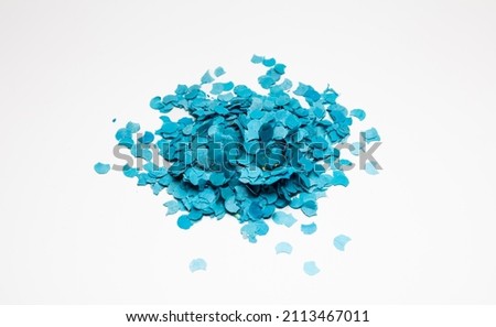 Confetti blue color heap isolated cutout on white background. Overhead view of circle paper pile, festive, carnival, celebration party.