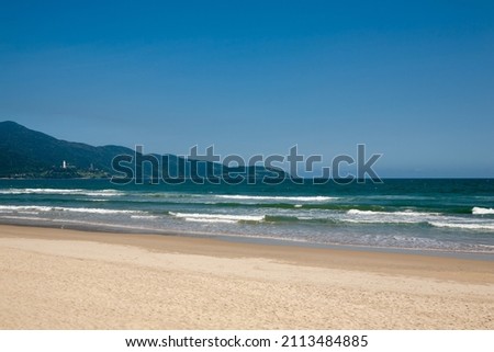 The scenery of a vacation spot with sandy beaches and waves.