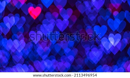 Bokeh background with blue and pink hearts on black background. Love concept. Theme for Valentine's Day. High quality photo