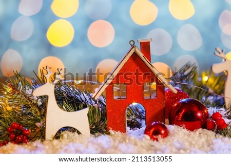 Composition with Christmas decorations and fir branches on snow against blurred lights, closeup
