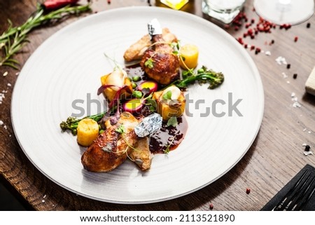 Chicken fillet, Jerusalem artichoke puree, dewberry sauce, potato, quail egg. Delicious healthy traditional food closeup served for lunch in modern gourmet cuisine restaurant Royalty-Free Stock Photo #2113521890