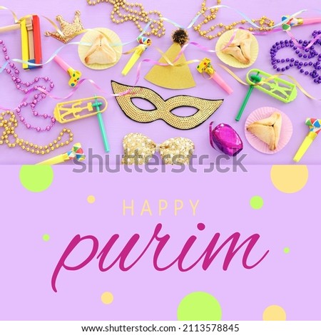 Purim celebration concept (jewish carnival holiday) over purple wooden background