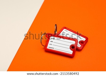 New plastic key tags on color background