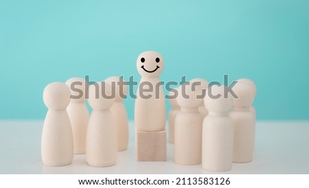 Wood person model among people Smiling .Successful team leader concept. Royalty-Free Stock Photo #2113583126