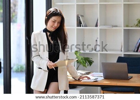 Gorgeous asian businesswoman working at modern workplace.