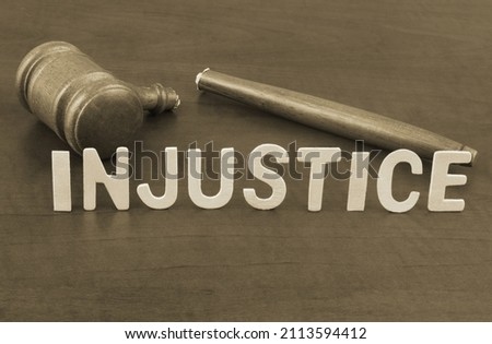 Broken judge gavel and word injustice. Concept of iniquity, injustice and lawlessness.	 Royalty-Free Stock Photo #2113594412
