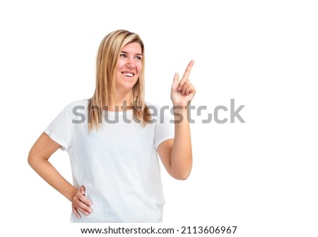 Young woman pointing to copy space isolated on white background