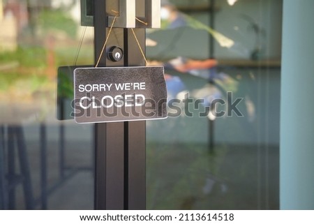"sorry we're closed" label in front of glass door at the coffee shop to notice customer service                                                             Royalty-Free Stock Photo #2113614518