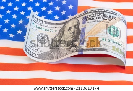 U.S. 100 dollar banknote on american flag background for design purpose