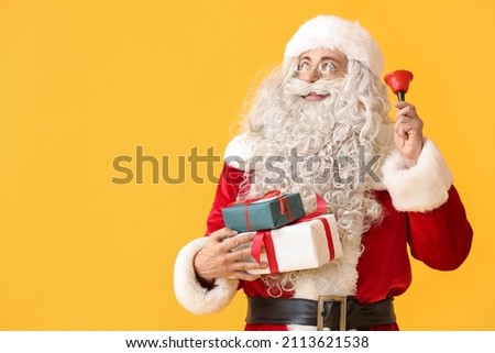 Santa Claus with Christmas bell and gift boxes on yellow background