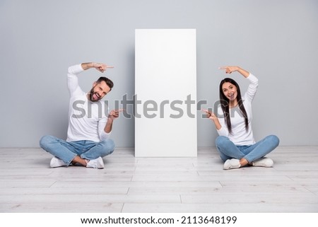 Portrait of attractive cheerful couple demonstrating new novelty copy blank space ad isolated over grey pastel color background Royalty-Free Stock Photo #2113648199