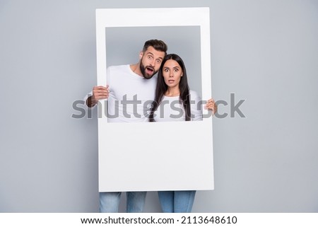Photo of impressed young couple do picture wear shirt jeans isolated on grey background