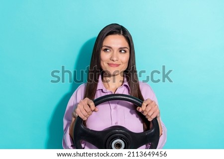 Photo of careful driver lady look empty space hold steering wheel wear purple shirt isolated turquoise color background Royalty-Free Stock Photo #2113649456