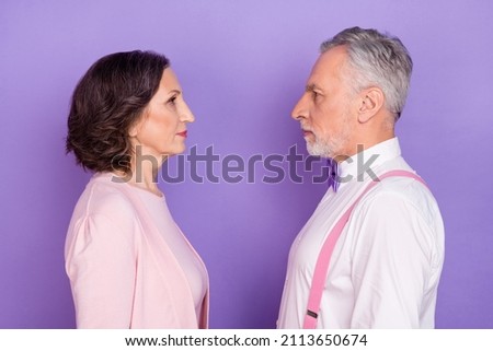 Profile photo of calm focused persons look each other isolated on pastel purple color background