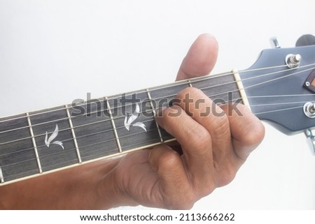 Closeup man's finger playing guitar chords, Chord A minor (Am) Royalty-Free Stock Photo #2113666262