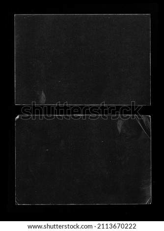 Old Black Empty Aged Damaged Paper Cardboard Photo Card Isolated on Black. Real Halftone Scan. Folded Edges. Rough Grunge Shabby Scratched Torn Ripped Texture. Distressed Overlay Surface for Collage.  Royalty-Free Stock Photo #2113670222