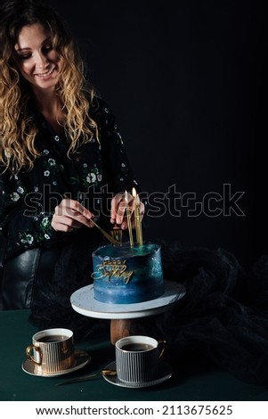 a woman cuts a sweet cake for food