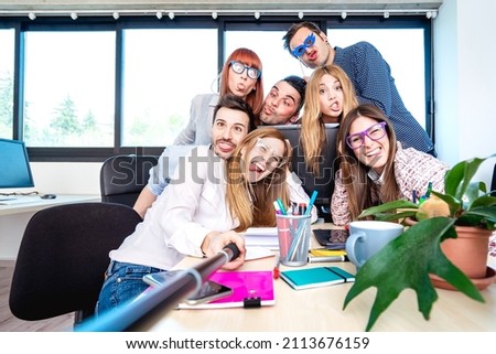 Young people employee workers taking happy selfie with stick - Life style concept of human resource on working fun time - Startupper at college office - Bright azure filter