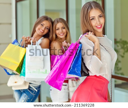 Young girls with shopping bags in shop