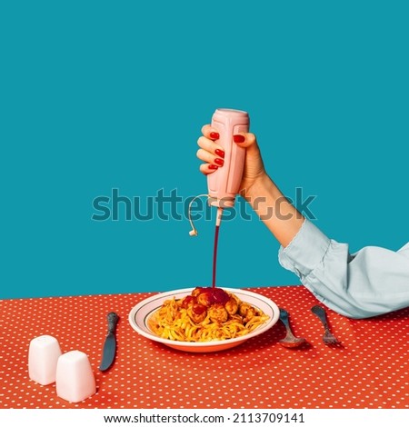 Add tomatoes. Food pop art photography. Female hands tasting spaghetti with meatballs on plaid tablecloth isolated on bright blue background. Vintage, retro style interior. Complementary colors