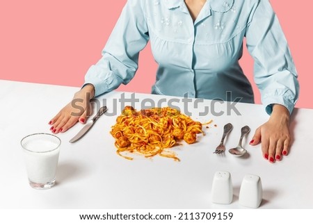 Creative portrait of young woman wearing vintage style clothes ready to eat spaghetti with meatballs. Vintage, retro style interior. Food pop art photography. Blue, white and pink. Surrealism