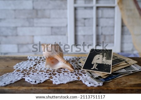 stack of vintage photos, old photography of 1960 on wooden table, concept of genealogy, the memory of ancestors, family tree, genealogy, childhood memories, family archive