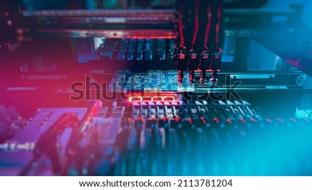 Chip Production: Machine Vision System inspect PCB for the number, size, and placement of components while and SMT manufacturing. Automatic production of computer chips by SMT Pick and Place machine.  Royalty-Free Stock Photo #2113781204