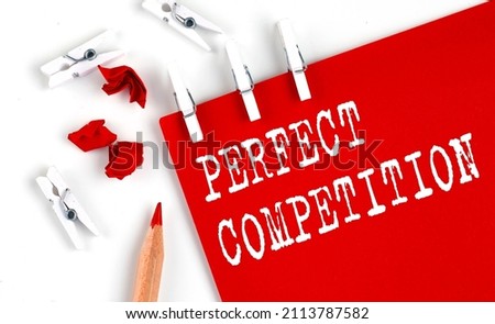 PERFECT COMPETITION text on red paper with office tools on the white background