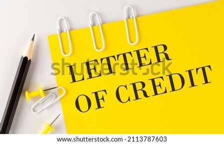 LETTER OF CREDIT word on the yellow paper with office tools on white background