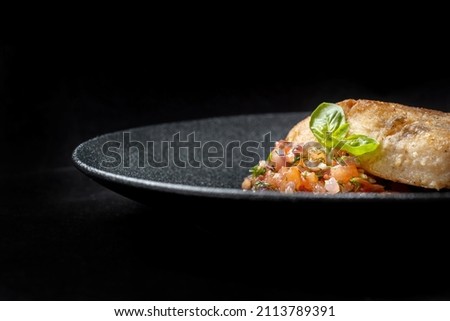 Delicious fish fry served on a beautiful plate, laid out on tartare. Very voluminous picture