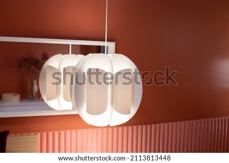 Suspended white lamp isolated on blurred background. Modern chandelier in Scandinavian style.modern interior room with a beautiful furniture.living room in modern design