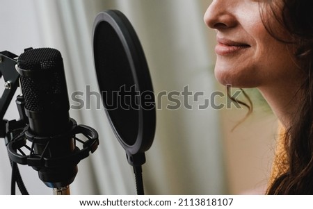 Singer recording song for new album inside music production studio - Happy woman doing radio podcast