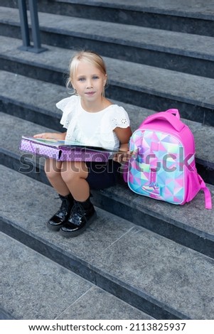Children learn smart. Street student. Happy preschool kid. Back to school. Schoolgirl with a backpack and books. Modern education. Private schooling. Blonde girl with backpack. Stylish schoolgirl.